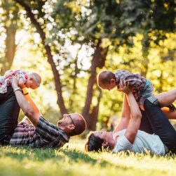 A joyful family enjoying playtime in a sunny park, capturing moments of laughter and happiness.